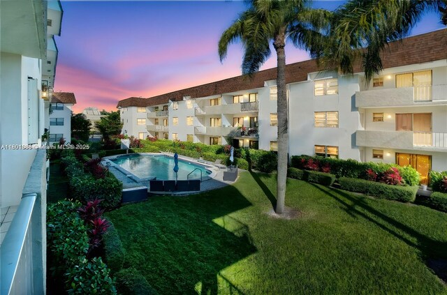 9020 NE 8th Ave Unit 2A, Miami Shores, FL 33138 - view of swimming pool featuring a lawn