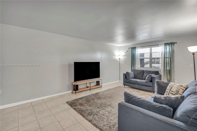 9020 NE 8th Ave Unit 2A, Miami Shores, FL 33138 - living area featuring light tile patterned flooring and baseboards