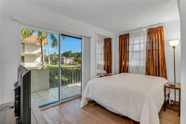 9020 NE 8th Ave Unit 2A, Miami Shores, FL 33138 - bedroom with access to outside and wood finished floors