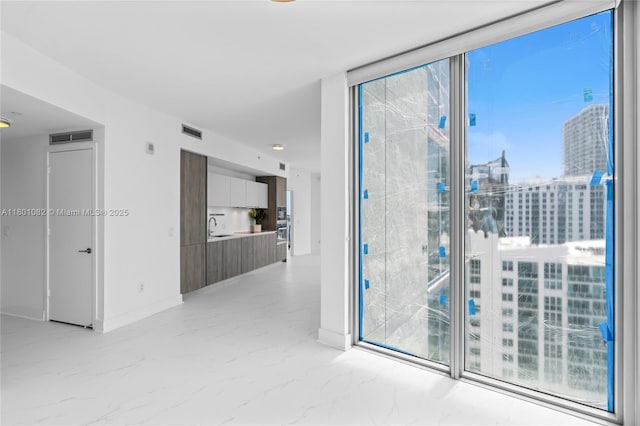 2900 NE 7th Ave Unit 1409, Miami, FL 33137 - spare room with light marble finish floors and a wall of windows