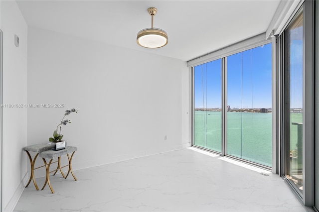 2900 NE 7th Ave Unit 1409, Miami, FL 33137 - spare room featuring healthy amount of natural light, a water view, marble finish floors, and expansive windows