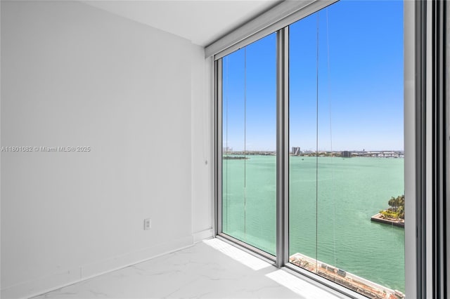 2900 NE 7th Ave Unit 1409, Miami, FL 33137 - spare room featuring a water view, marble finish floors, and healthy amount of natural light