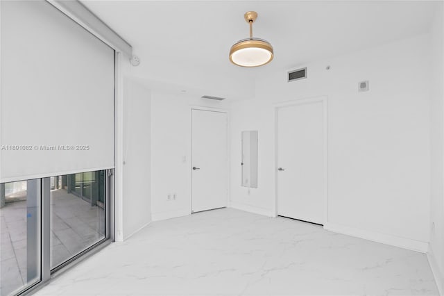 2900 NE 7th Ave Unit 1409, Miami, FL 33137 - empty room featuring marble finish floors and a smoke detector