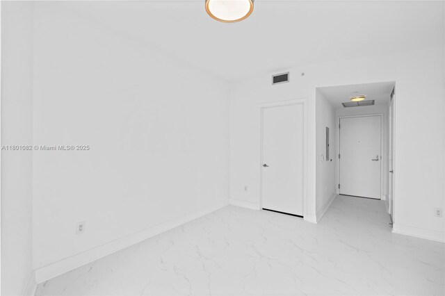 2900 NE 7th Ave Unit 1409, Miami, FL 33137 - empty room with light marble finish floors and baseboards