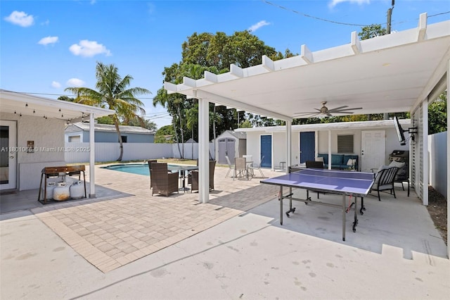 6811 SW 5th Ter, Miami, FL 33144 - view of patio / terrace with a storage unit, outdoor dining area, an outdoor structure, a fenced backyard, and ceiling fan