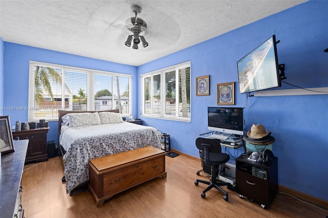 6811 SW 5th Ter, Miami, FL 33144 - bedroom featuring wood finished floors, baseboards, ceiling fan, and a textured ceiling