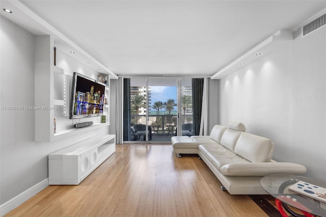 5700 Collins Ave Unit 4A, Miami Beach, FL 33140 - living area featuring wood finished floors, expansive windows, recessed lighting, and baseboards