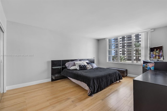 5700 Collins Ave Unit 4A, Miami Beach, FL 33140 - bedroom with light wood-style floors and baseboards