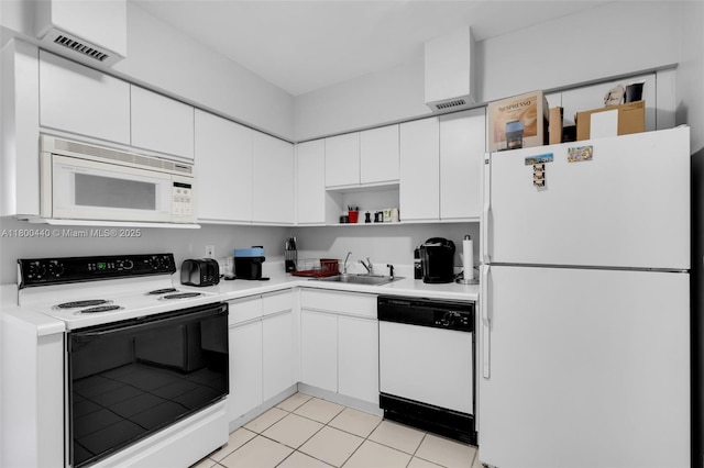 5700 Collins Ave Unit 4A, Miami Beach, FL 33140 - kitchen featuring white appliances, a sink, white cabinetry, and light countertops
