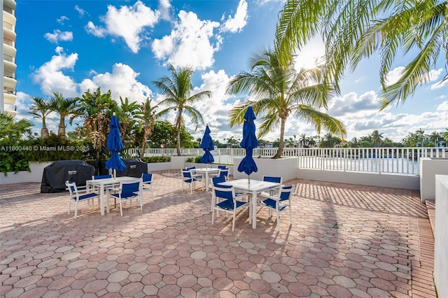 5700 Collins Ave Unit 4A, Miami Beach, FL 33140 - view of patio / terrace featuring outdoor dining space, fence, and area for grilling