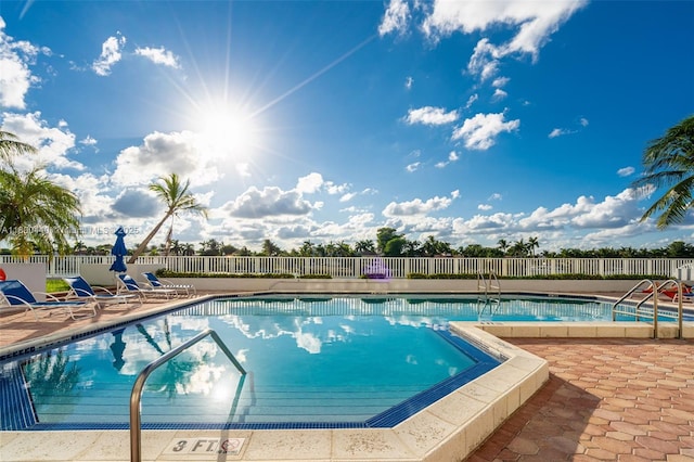 5700 Collins Ave Unit 4A, Miami Beach, FL 33140 - community pool with a fenced backyard and a patio area