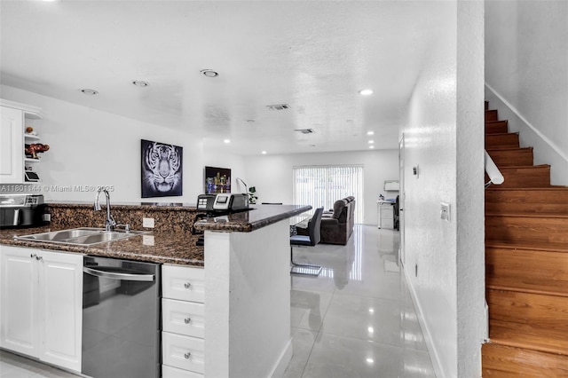 6306 Moseley St Unit 1, Hollywood, FL 33024 - kitchen with dishwasher, a sink, a peninsula, white cabinets, and dark stone counters