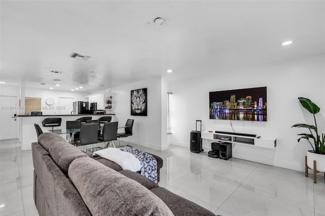 6306 Moseley St Unit 1, Hollywood, FL 33024 - living room with light tile patterned floors, recessed lighting, and baseboards