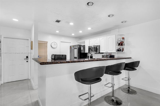 6306 Moseley St Unit 1, Hollywood, FL 33024 - kitchen with smart refrigerator, stainless steel microwave, baseboards, white cabinets, and light tile patterned floors