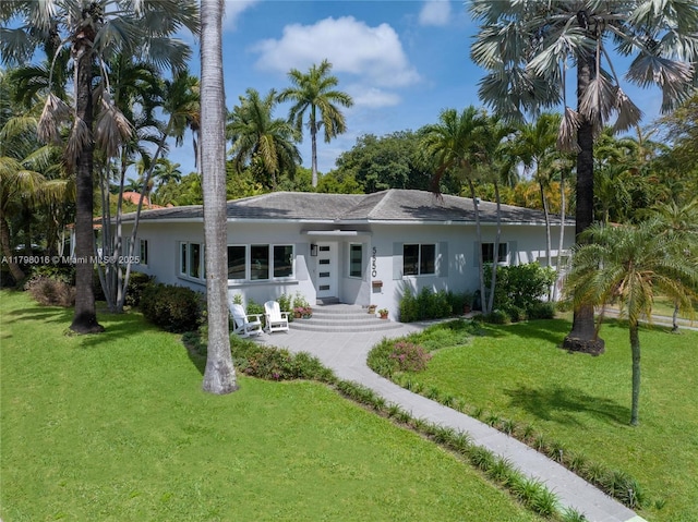 5550 N Bayshore Dr, Miami, FL 33137 - ranch-style house with a front yard and stucco siding