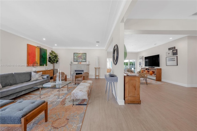 5550 N Bayshore Dr, Miami, FL 33137 - living room with light wood-style floors, recessed lighting, ornamental molding, and a tile fireplace