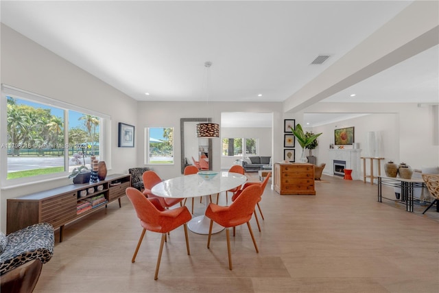 5550 N Bayshore Dr, Miami, FL 33137 - dining area with recessed lighting, light wood finished floors, and a fireplace