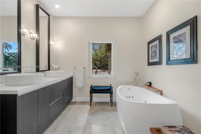 5550 N Bayshore Dr, Miami, FL 33137 - full bathroom with a soaking tub, double vanity, tile patterned floors, and recessed lighting