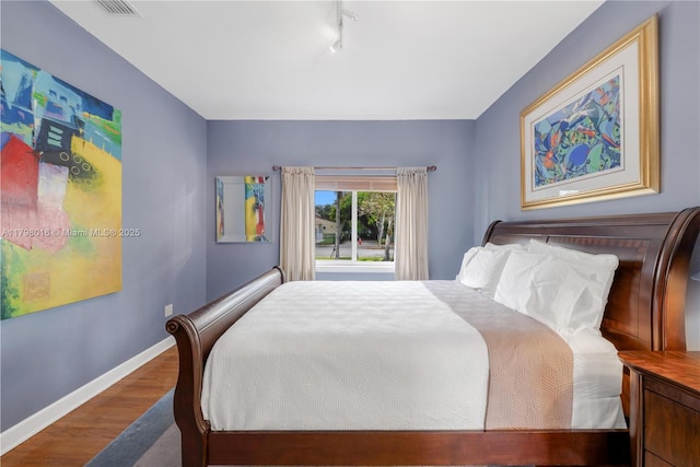 5550 N Bayshore Dr, Miami, FL 33137 - bedroom featuring track lighting and wood finished floors