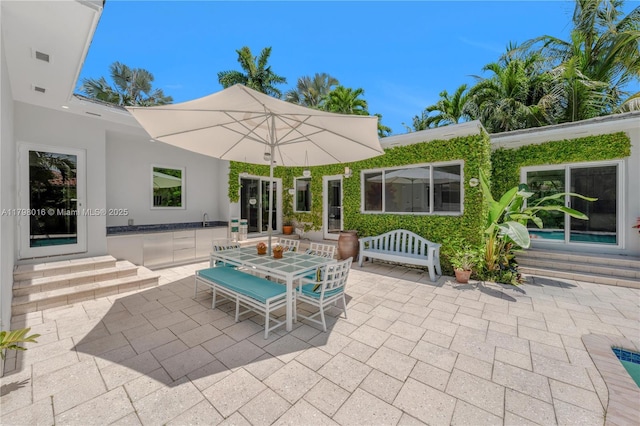 5550 N Bayshore Dr, Miami, FL 33137 - view of patio with entry steps and outdoor dining area