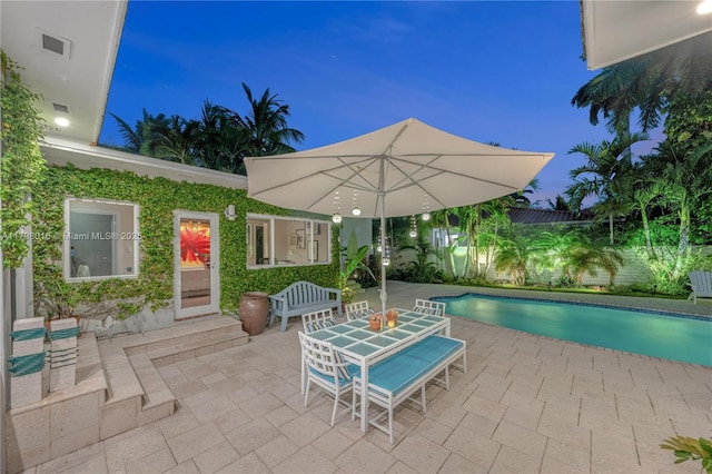 5550 N Bayshore Dr, Miami, FL 33137 - patio at night with a patio area and outdoor dining area