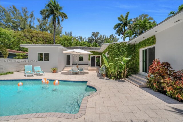 5550 N Bayshore Dr, Miami, FL 33137 - view of swimming pool with entry steps and a patio area
