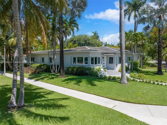 5550 N Bayshore Dr, Miami, FL 33137 - ranch-style home featuring stucco siding and a front yard