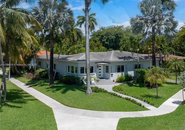 5550 N Bayshore Dr, Miami, FL 33137 - single story home featuring a front yard and stucco siding