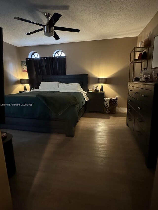 8389 NW 8th St, Miami, FL 33126 - bedroom featuring a textured ceiling, wood finished floors, and a ceiling fan
