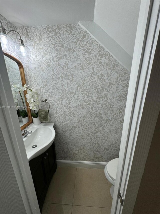 8389 NW 8th St, Miami, FL 33126 - bathroom featuring wallpapered walls, vanity, baseboards, toilet, and tile patterned flooring
