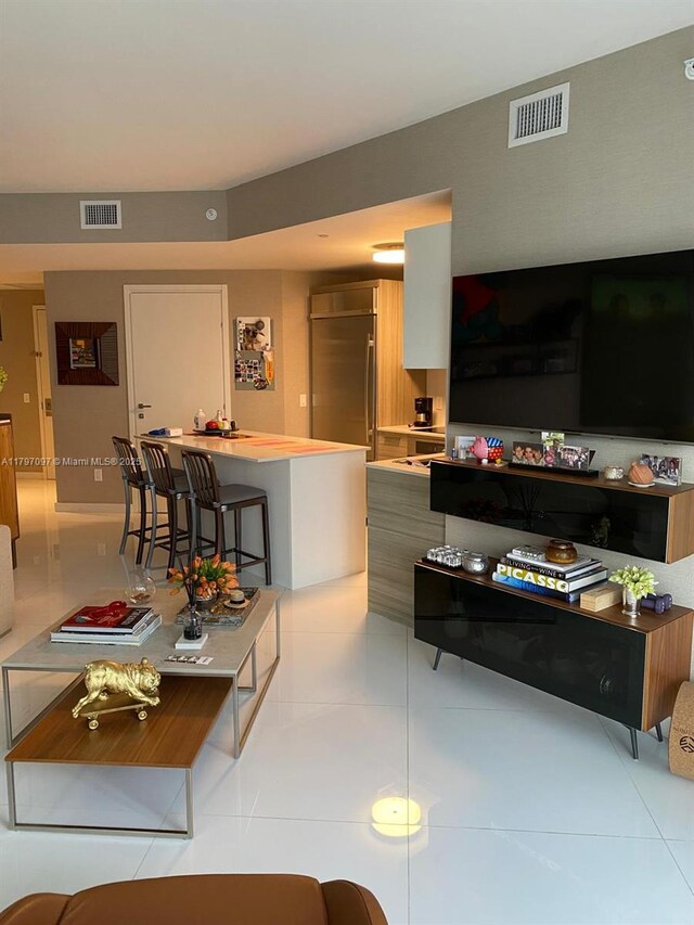 living room with light tile patterned flooring