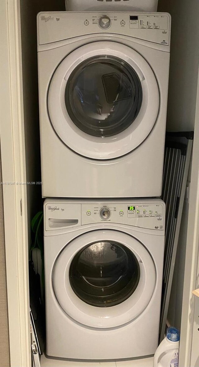 laundry area with stacked washing machine and dryer