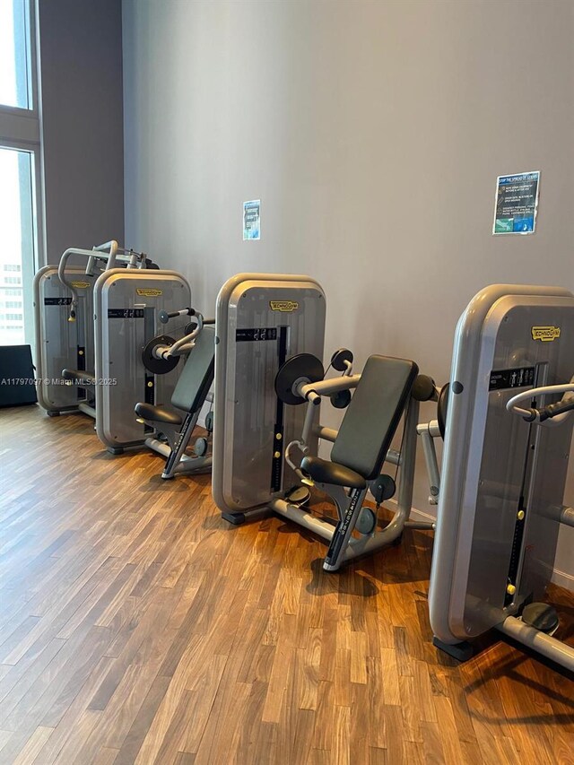 exercise room with wood finished floors