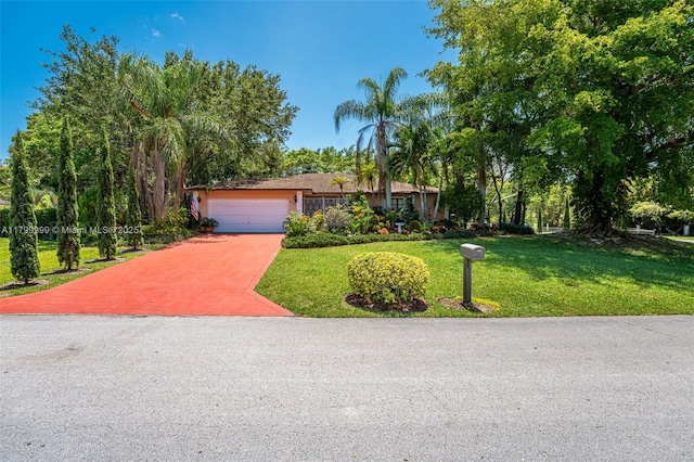 8620 SW 181st St, Palmetto Bay, FL 33157 - view of front of home featuring a garage, a front yard, and driveway