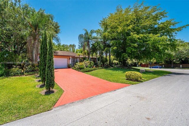 8620 SW 181st St, Palmetto Bay, FL 33157 - view of front of home featuring a garage, a front lawn, and driveway