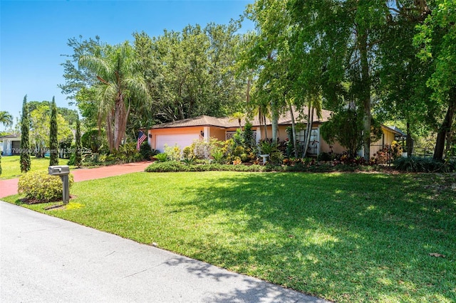 8620 SW 181st St, Palmetto Bay, FL 33157 - view of front of house with an attached garage, a front lawn, and driveway