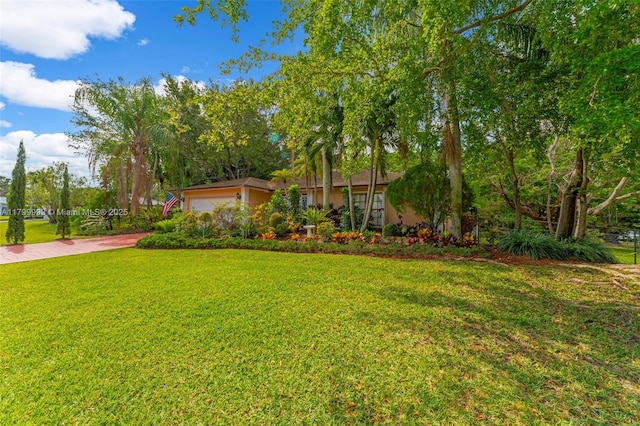 8620 SW 181st St, Palmetto Bay, FL 33157 - view of grassy yard with an attached garage and driveway
