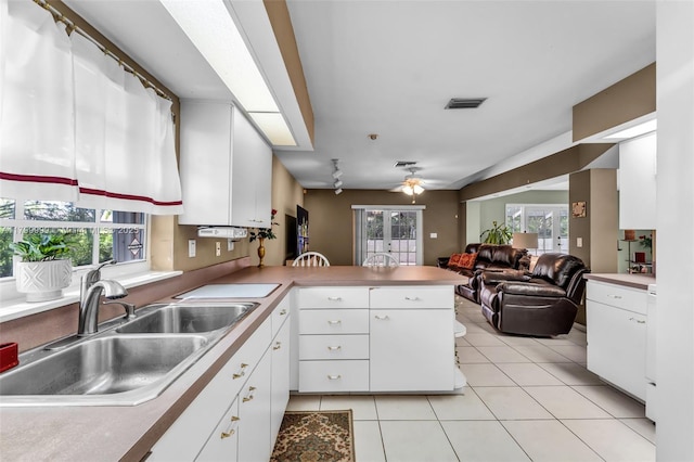 8620 SW 181st St, Palmetto Bay, FL 33157 - kitchen featuring a sink, a peninsula, light tile patterned floors, ceiling fan, and white cabinets