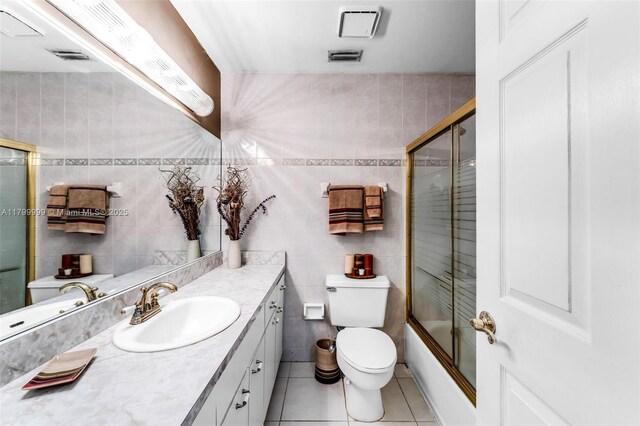 8620 SW 181st St, Palmetto Bay, FL 33157 - full bath featuring tile walls, tile patterned floors, vanity, toilet, and combined bath / shower with glass door
