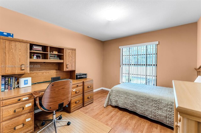 8620 SW 181st St, Palmetto Bay, FL 33157 - bedroom with light wood finished floors, an office area, and baseboards