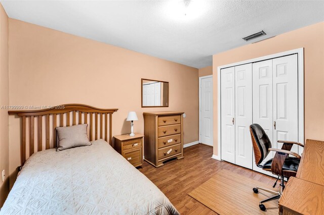 8620 SW 181st St, Palmetto Bay, FL 33157 - bedroom with wood finished floors, a closet, an office area, and baseboards
