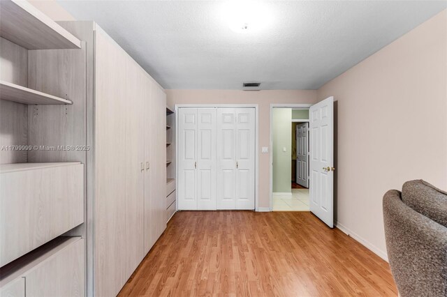 8620 SW 181st St, Palmetto Bay, FL 33157 - bedroom with light wood-style floors, a closet, and baseboards