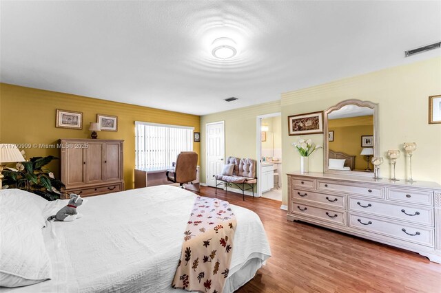 8620 SW 181st St, Palmetto Bay, FL 33157 - bedroom with light wood finished floors and ensuite bath