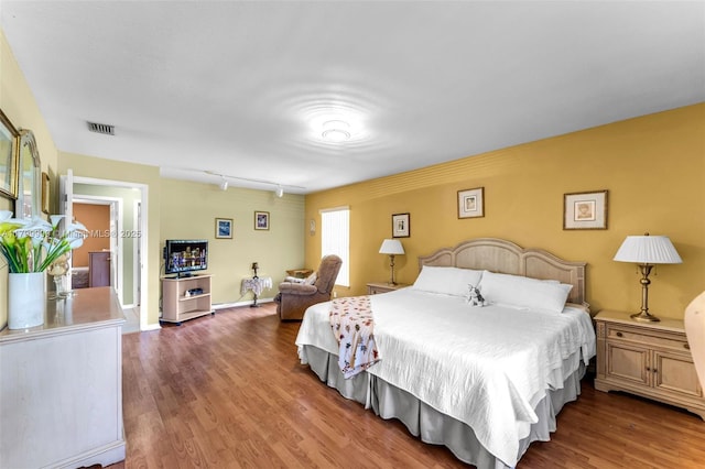 8620 SW 181st St, Palmetto Bay, FL 33157 - bedroom with wood finished floors, track lighting, and baseboards