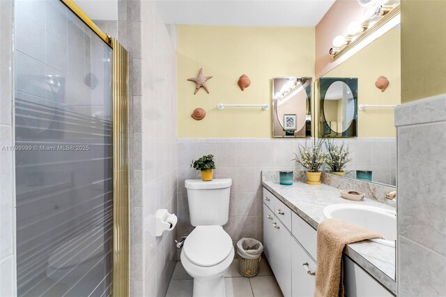 8620 SW 181st St, Palmetto Bay, FL 33157 - bathroom featuring tile walls, tile patterned floors, a wainscoted wall, vanity, and a stall shower