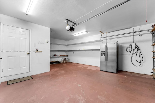 8620 SW 181st St, Palmetto Bay, FL 33157 - garage with stainless steel refrigerator with ice dispenser and a garage door opener