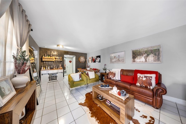 569 SW 4th St, Miami, FL 33130 - living area featuring a dry bar, light tile patterned flooring, and baseboards