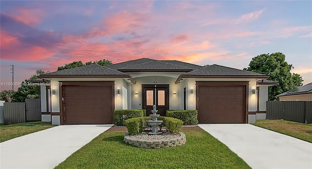 view of front of house featuring concrete driveway, stucco siding, and a garage