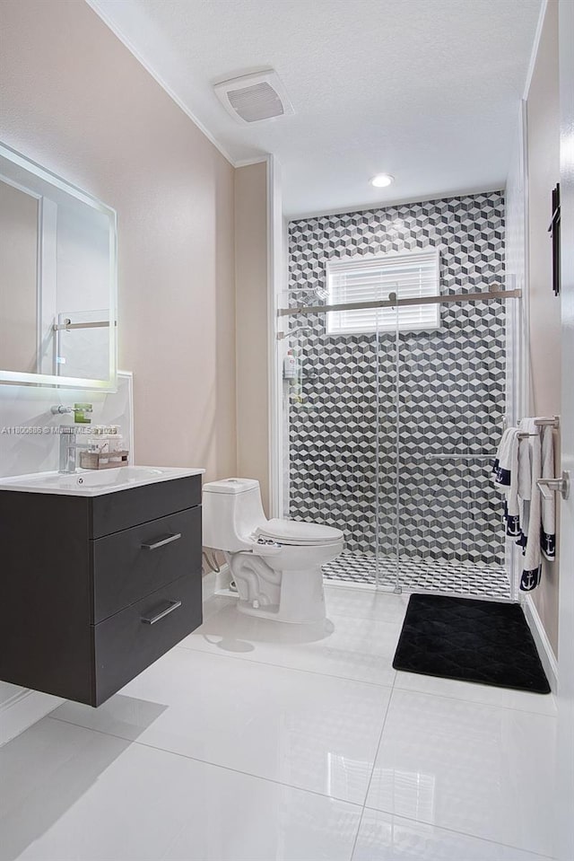 bathroom with toilet, a shower stall, vanity, and tile patterned flooring