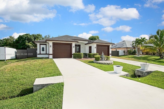 view of front facade featuring a garage, driveway, and stucco siding